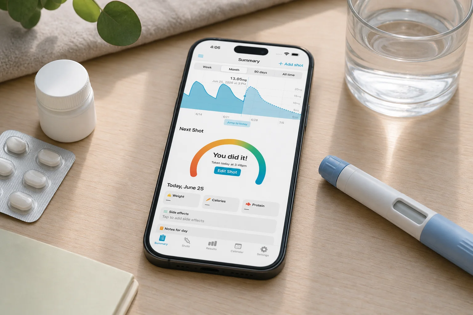 Shotsy app on a phone beside a pill blister, pill bottle, water, and GLP-1 injection pen